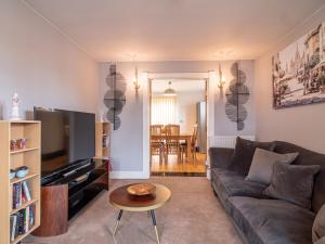 a living room with a couch and a table at Grandeur Homes Sheffield in Heeley