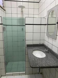 a bathroom with a sink and a mirror at Hotel Central Gold in Manaus