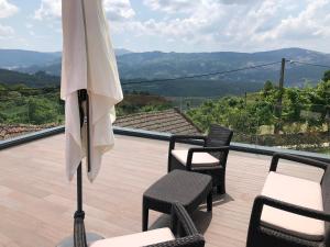 a patio with two chairs and an umbrella at House with Private Pool in Cabeceiras de Basto - 250 m² in Cabeceiras de Basto