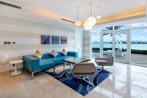 a living room with a blue couch and a table at FAM Living - Sarai Beach Villas - Palm Jumeirah - Families Only in Dubai