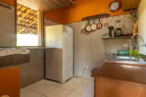 a kitchen with a refrigerator and a sink at Casa de Maria na Praia de Atins in Atins