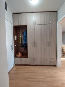 a closet with wooden cabinets in a room at Xenia apartments in Belgrade