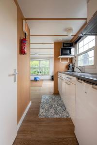 - une cuisine avec un évier et un comptoir dans l'établissement 87, gelegen in het rustige & bosrijke Oisterwijk!, à Oisterwijk