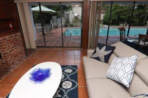 a living room with a couch and pillows and a pool at La Finca in Miami