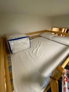 a bunk bed with a white mattress and a pillow at Studio à 400m du front de neige LES ORRES 1650 in Le Mélézet