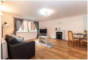 a living room with a couch and a table at Citrine - 2 Bed Apartment With Parking in Reading