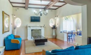 a living room with blue furniture and a fireplace at 268 On Ridge Guesthouse in Durban