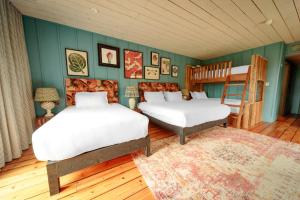 two beds in a room with green walls at Glasson LakeHouse in Athlone