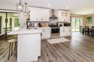 a kitchen with white cabinets and a kitchen island at New 6min to 3 Sister Springs, Spacious, Fun with Game Room in Crystal River