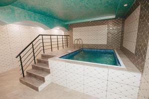 a jacuzzi tub in a room with a staircase at Castle Resort Spa Hotel in İsmayıllı