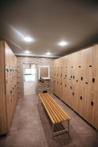 a room with wooden lockers and a bench at Castle Resort Spa Hotel in İsmayıllı