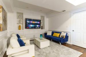 a living room with two blue couches and a tv at Relaxing Retreat with 55-Inch TV and Lake Views in Stone Mountain