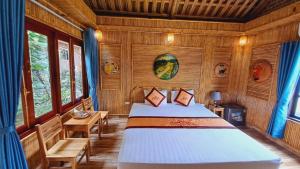 a bedroom with a bed in a wooden room at Tam Coc Amanda Villas in Ninh Binh