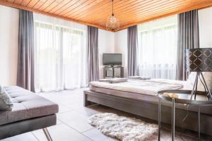 1 dormitorio con 1 cama grande y 1 sofá en Ferienwohnung Wallmerhof am ländlichen Wimberg en Adnet