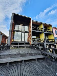 a building with a large window on a wooden deck at Hotel & Café Bauda in Castro