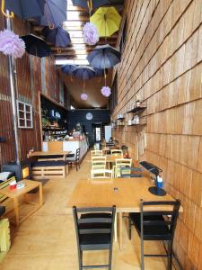 a restaurant with tables and chairs and umbrellas on the wall at Hotel & Café Bauda in Castro