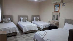 Postel nebo postele na pokoji v ubytování Hotel Pamukkale
