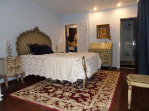 a bedroom with a bed and a dresser at Casal de S.Romão do Meio in Guimarães