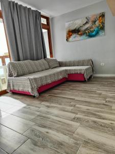 a living room with a couch in the corner at Apartamentos Australia in Playa del Ingles