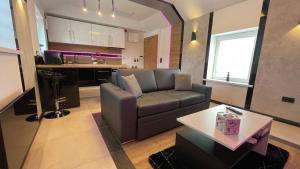 a living room with a couch and a table at #3 TGHA Luxury One Bedroom Apartment in Athlone in Athlone