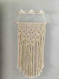 a beige fringe curtain hanging on a wall at Apartamentos Australia in Playa del Ingles