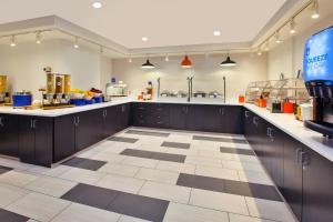a large kitchen with brown cabinets and a checkered floor at Holiday Inn Express Philadelphia-Midtown, an IHG Hotel in Philadelphia