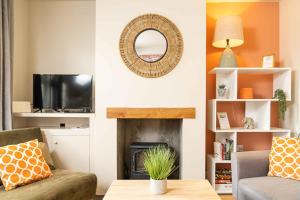 a living room with a fireplace and a mirror at East Street, Town Centre, 2 Bedrooms in Tewkesbury