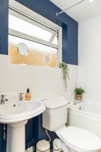 a bathroom with a white toilet and a sink at East Street, Town Centre, 2 Bedrooms in Tewkesbury