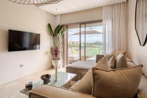 a living room with a couch and a tv at Findy Golf City in Marrakesh