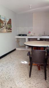 a kitchen with a table and chairs in a room at Hotel Villa Mary Apartaestudios playa in Puerto Colombia