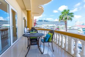 d'un balcon avec une table et des chaises et une vue sur l'océan. dans l'établissement Bay Harbor Luxury 1 bedroom apartments, à Oranjestad