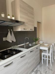 a kitchen with a sink and a stove at Affitta camere Tra mari e monti in Cecina +19 photos