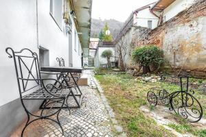 une table et des chaises assises à l'extérieur d'un bâtiment dans l'établissement StylishCozy Apartment, à Braşov