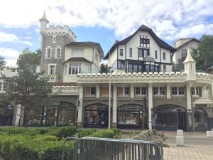 a large building with a castle in the background at AUBERGE RIVA BELLA in Le Touquet-Paris-Plage