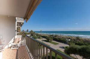 a balcony with a view of the ocean at LETS HOLIDAYS Beach front apartment in Gavà Mar, Pine Beach in Gavà