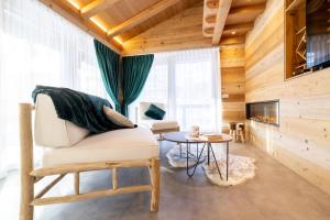 a living room with a chair and a table at Chalet Imbosc'chè in Livigno