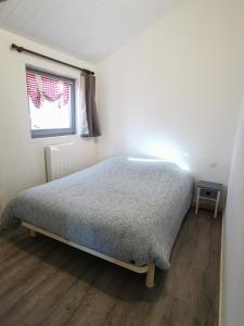 - une chambre avec un lit dans une pièce dotée d'une fenêtre dans l'établissement Chalet entre lacs et montagnes, à Saulxures-sur-Moselotte