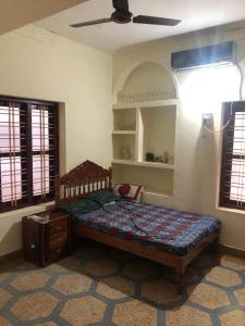 um quarto com uma cama e uma ventoinha de tecto em Konni Town Central House with AC rooms em Koni