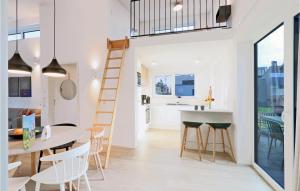 a kitchen and dining room with a ladder and a staircase in a house at Awesome Home In Lembruch-dmmer See With Sauna in Lembruch