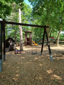 a swing set in a park with a playground at Ferienwohnung Freyas Walderlebnis in Stromberg