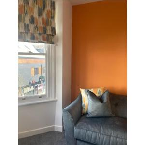 a living room with a couch and a window at Printer's Apartment in Pontefract