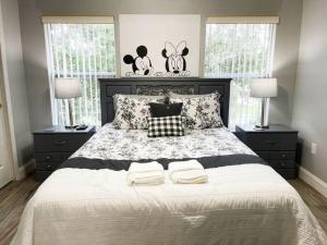 a bedroom with a large bed with two pillows at 3BR Townhouse Next to Disney in Orlando