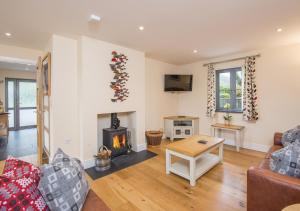 a living room with a couch and a fireplace at Hafod Aber in Rhyd-y-felin