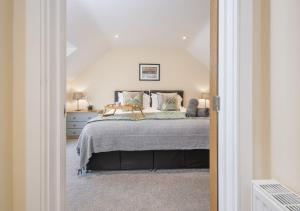a bedroom with a bed and a white ceiling at Hafod Aber in Rhyd-y-felin