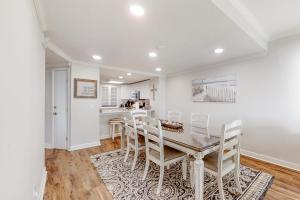 a kitchen and dining room with a table and chairs at Turtle Sea Dunes II in Fernandina Beach