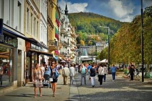 a group of people walking down a busy city street at Vila Daniela in Karlovy Vary