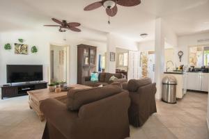 a living room with two couches and a tv at Casa Karlina in Palm-Eagle Beach