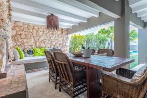 a dining room with a wooden table and chairs at Casa Karlina in Palm-Eagle Beach