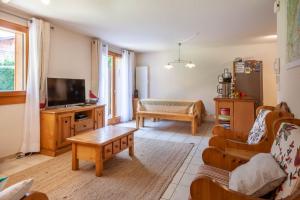 ein Wohnzimmer mit einem Sofa und einem Tisch in der Unterkunft JEANETTE 2 in Morzine
