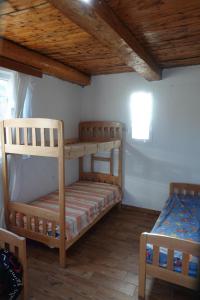 a bedroom with two bunk beds and a ceiling at Guesthouse Arber in Peshkopi